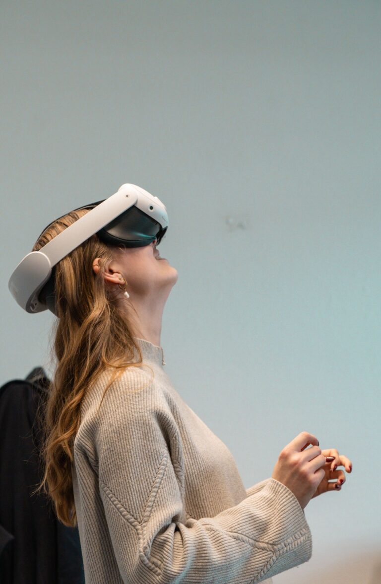 A woman wearing a virtual reality headset, immersed in a digital experience indoors.